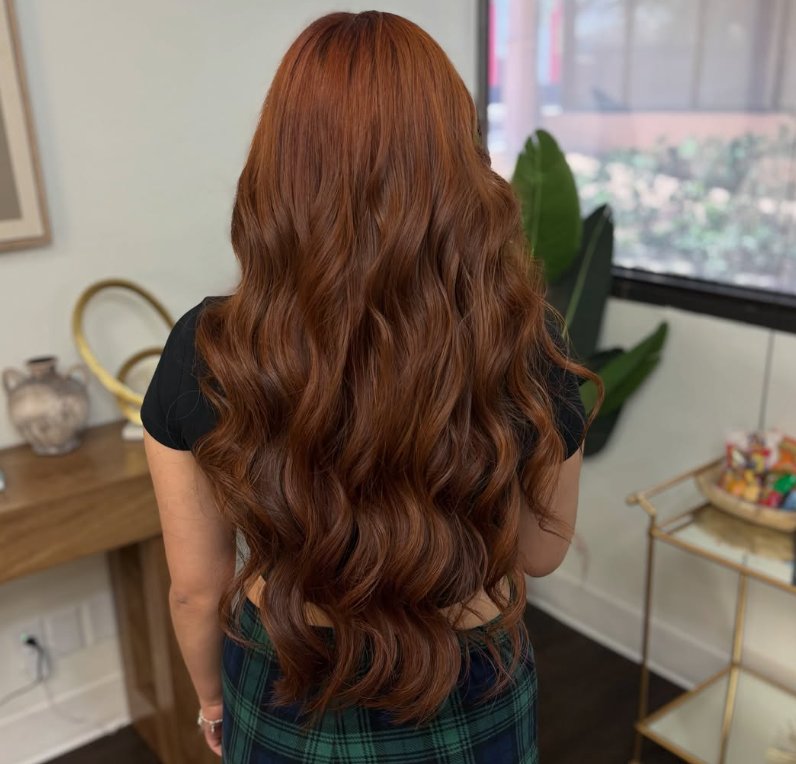 Long copper-toned hair styled in Hollywood waves at The Vault