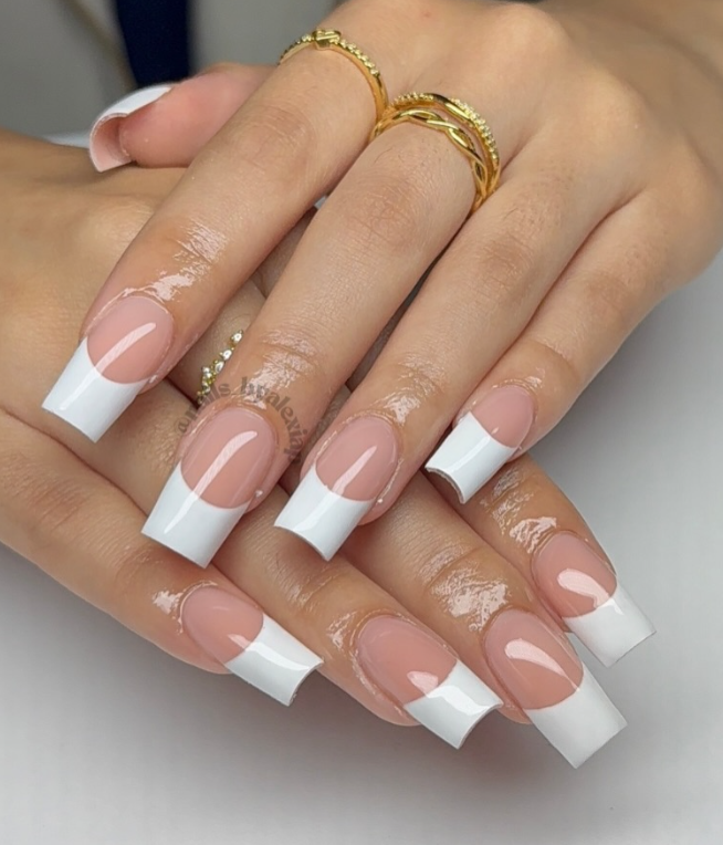 Classic French manicure with long square nails and gold rings